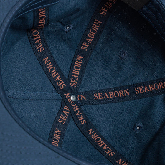 detail photo of inside taping. seaborn text in salmon on dark blue background.